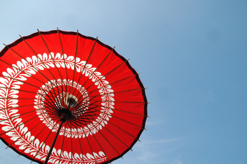 Japanese red umbrella against blue sky