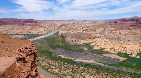 Epic view of Colorado river and Utah desert from Hite Overlook vista point on a very hot, sunny day of spring. Red mesa mountains and Utah desert. Travelling in the American West