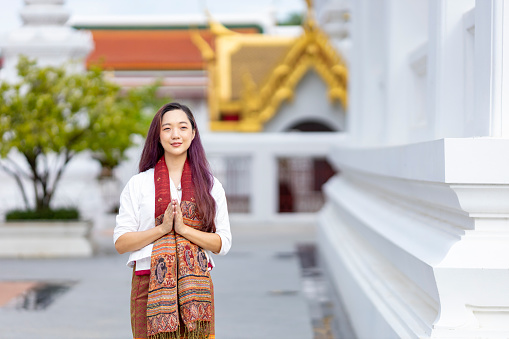 Buddhist asian woman is doing walking meditation around temple for peace and tranquil religion practice concept