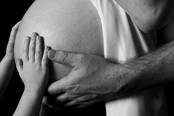 istock Family holding pregnant belly 140260253