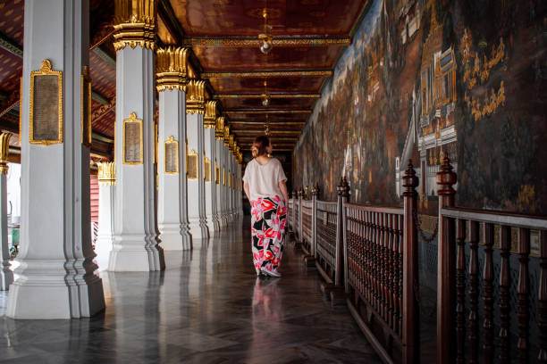 istock Young woman walking between temples in Bangkon, Thailand. 1402602534