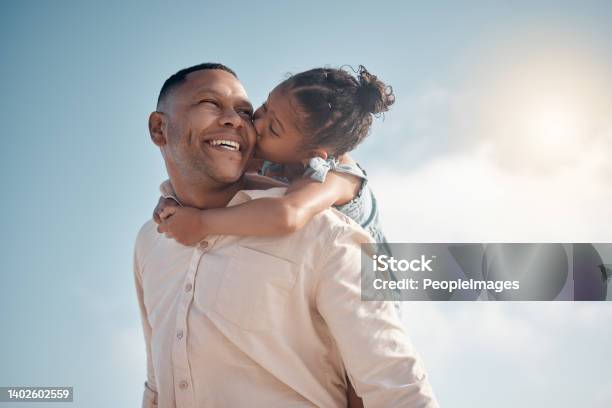 Smiling Mixed Race Single Father Carrying Little Daughter On Piggyback With Copyspace Adorable Happy Hispanic Girl Bonding With Parent And Kissing Cheek On Beach Man And Child Enjoying Free Time Stock Photo - Download Image Now