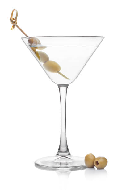 istock Vodka martini gin cocktail in classic glass with olives on bamboo stickwith fresh green olives on white background with reflection. 1402603196