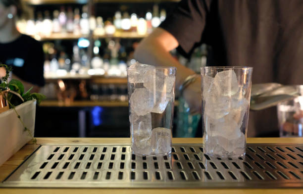 Bartender preparing cocktail with two glasses stock photo