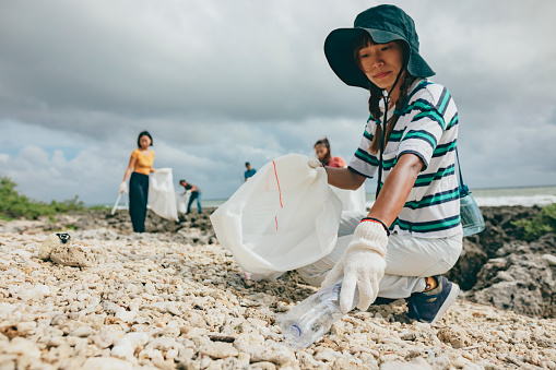Group of local people all coming together to clean up their local beach