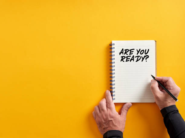 istock Male hand writing are you ready on a notepad. Are you ready concept. 1402604967