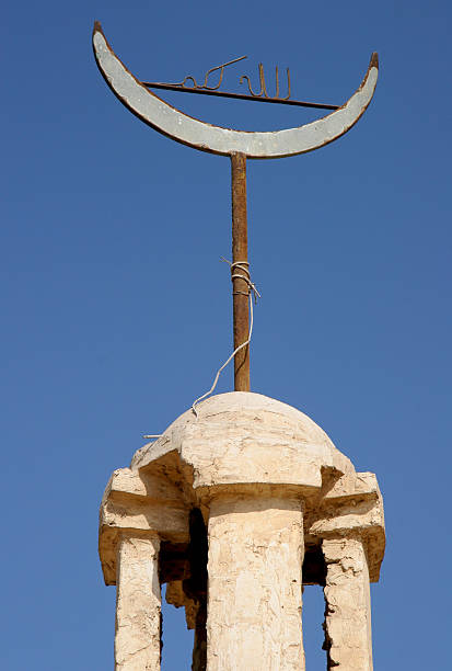 Rusty 'Allah Akbar' sign ontop of traditional minaret, Egypt stock photo