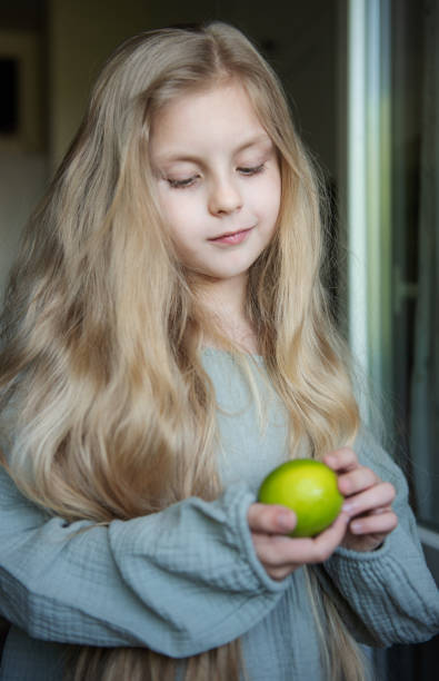 istock Beautiful little girl with lime 1402606901