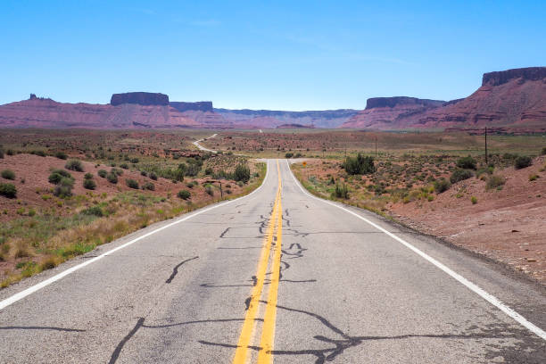 istock US road 128 winding through Utah desert between red cliffs on abeautiful day of spring. Scenic drive through American southwest. Riding a remote road. 1402607166