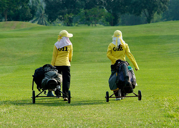 Two caddies on a golf course stock photo