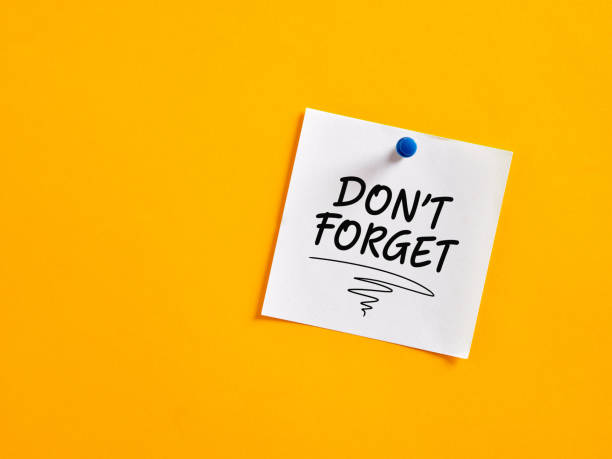 istock The notice reminder don't forget written on a note paper pinned on a yellow board. 1402607747