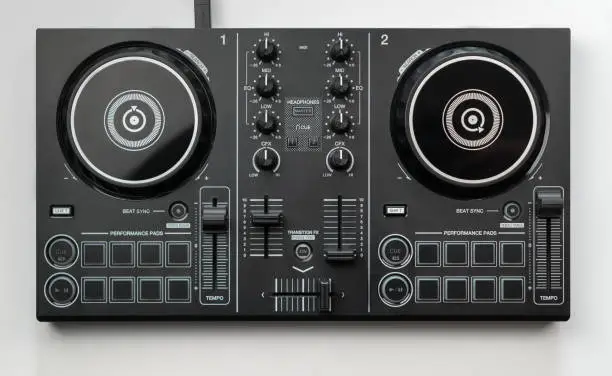 Photo of DJ mixing deck Controller connecting to Laptop and tablet using USB cable top view, isolated on white.