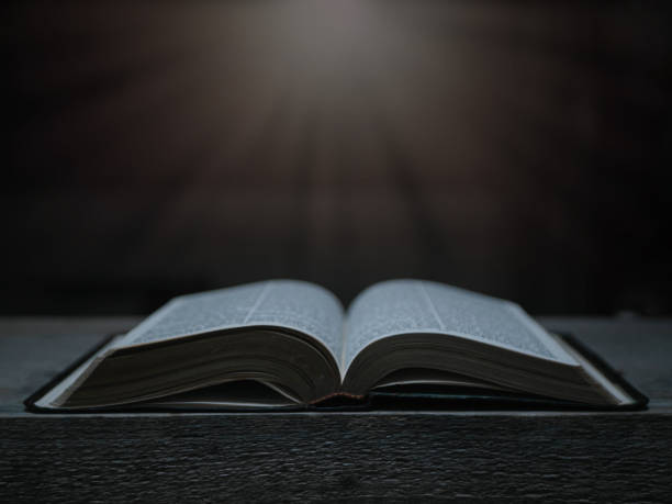istock Open Bible on a wood table with light coming from above. ( Church concept. ) 1402609630