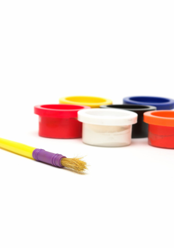 Creative paintbrush tools, equipment or objects for colorful and modern artwork, design and painting in an art studio or workshop. Jar or container of many different paint brushes in an empty room