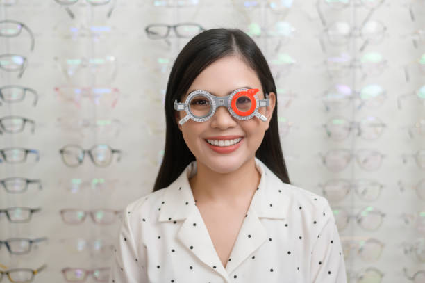 istock Young female customer being examined visual test using Bifocal Optometry eyesight measurement device by ophthalmologist in optical center, eyecare concept. 1402611273