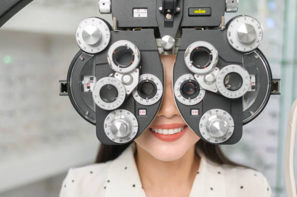 istock Young female customer being examined visual test using Bifocal Optometry eyesight measurement device by ophthalmologist in optical center, eyecare concept. 1402611275