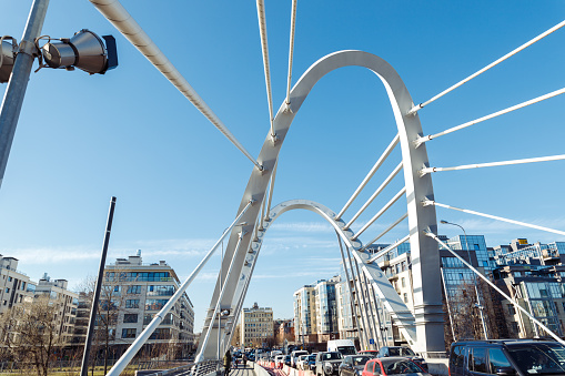 Saint Petersburg, Russia - 04.01.2022: Lazarevsky Bridge is road metal cable-stayed bridge across Malaya Nevka river. Cable stayed bridge supports, cable stays and blue sky, closeup