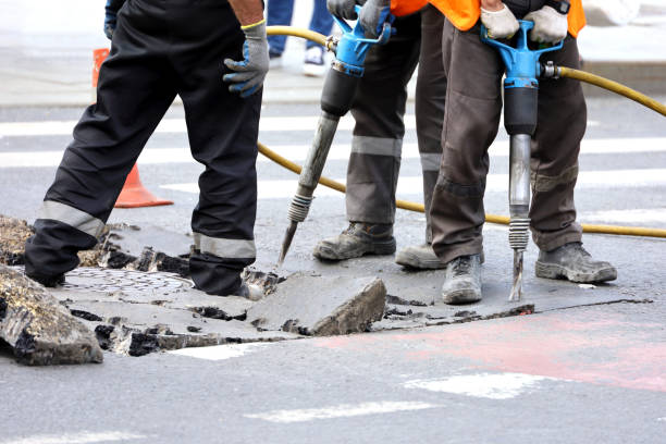 istock Workers repair the road surface with a jackhammer 1402613715