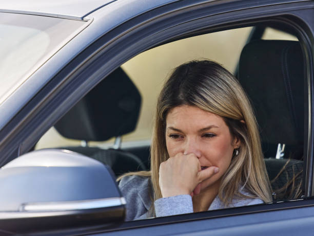 istock Young thoughtful woman in a car. 1402614263