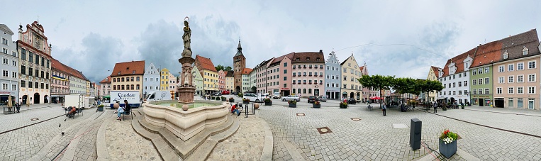 Landsberg, Germany - June, 9 - 2022:Landsberg, Germany - June, 9 - 2022: Market square with its typical, multi colored houses and the Marienbrunnen in the center. Right of it the Schmalzturm. On the left the magnificently renovated town hall. The historic town hall is the most striking and beautiful building on the entire square. The facade is richly decorated with stucco and was designed by Dominikus Zimmermann in 1719.