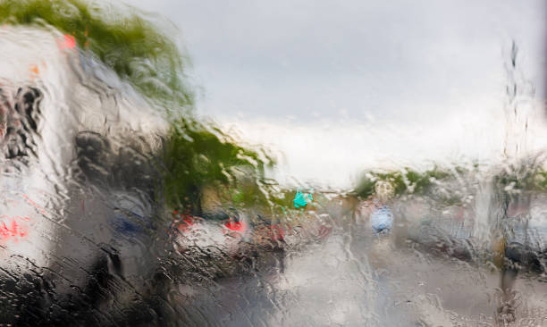 istock Driving on Queens Boulevard, New York, under torrential rain. The view through the windshield from the drover place. The street is defocused and distorted because of the water. 1402617029
