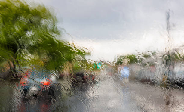 istock Driving on Queens Boulevard, New York, under torrential rain. The view through the windshield from the drover place. The street is defocused and distorted because of the water. 1402617034