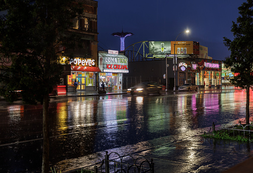 The street in Coney Island, Brooklyn, New York, USA in the night under torrential rain.