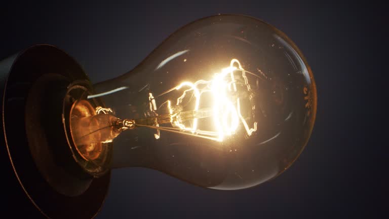 Light bulb glowing on a dark background