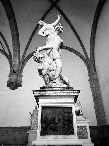 black and white photograph of the famous statue of Gianbologna, the Rape of the Sabines, located in the Loggia dei Lanzi in Piazza della Signoria in Florence.