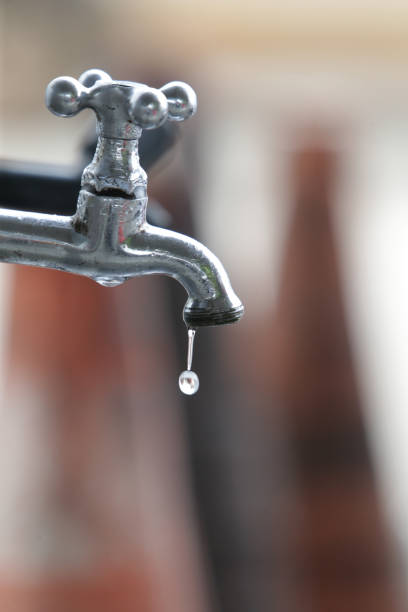faucet dripping water drop feira de santana, bahia, brazil - june 10, 2022: drop of water dripping on a tap of a gas station in the city of Feira de Santana. desert wash stock pictures, royalty-free photos & images