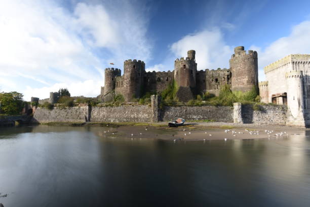 Conwy Castle Conwy Castle and the River Conwy and the castellation exit of the tubular railway bridge. conwy castle stock pictures, royalty-free photos & images