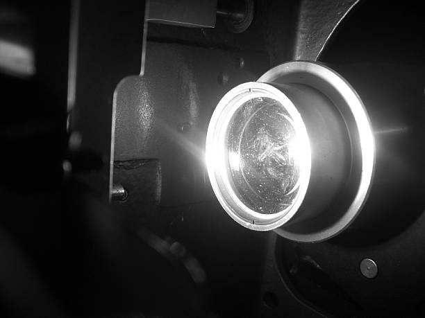 Movie projector with the film on the wooden floor