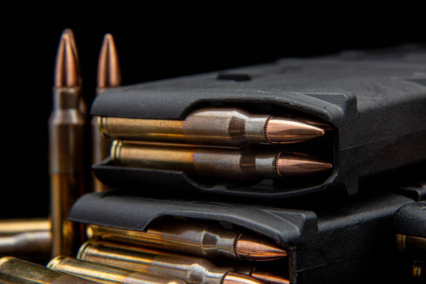 istock Bullet isolated on black background with reflexion. Rifle bullets close-up on black back. Cartridges for rifle and carbine on a black. 1402621047