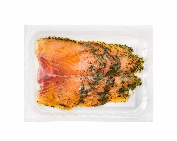 smoked salmon in a plastic tray isolated on white stock photo