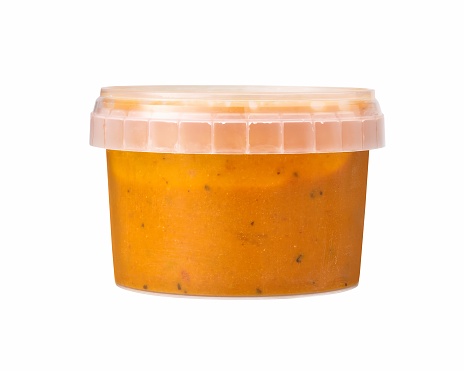 pasta sauce in plastic container isolated on white.