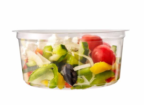 greek salad with fetta in plastic container stock photo