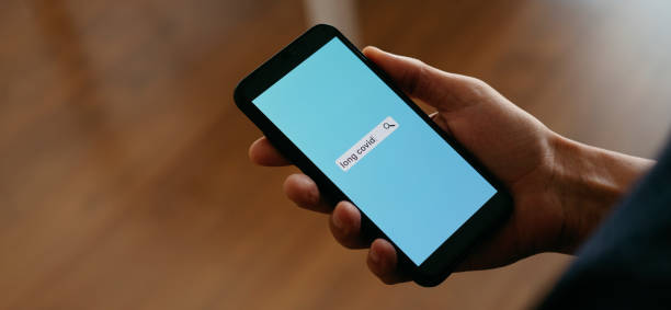 istock text long covid in his smartphone, web banner 1402621795