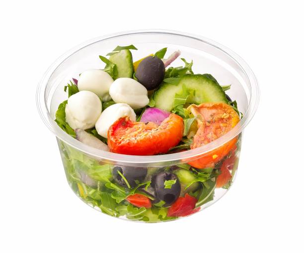 italian salad with mozzarella in plastic container stock photo