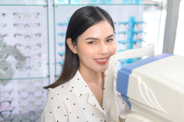 istock Young female customer being examined visual test using autorefractor by ophthalmologist in optical center, eyecare concept. 1402622808
