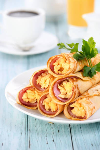 istock Homemade thin pancakes with a slice of ham and scrambled eggs 1402623098