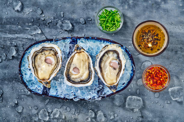 istock Open fresh raw oyster clams isolated and ready to eat 1402624724