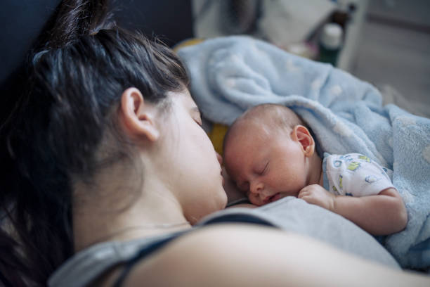 istock Mother and baby boy sleeping and cuddling. 1402625099