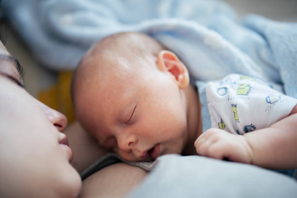 istock Mother and baby boy sleeping and cuddling. 1402625109