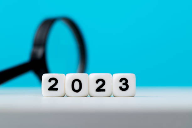 istock New year 2023 and magnifying glass on the table 1402625607