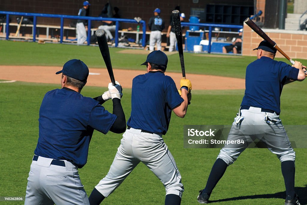 Batters Up Three baseball players lined up taking practice swings Back Stock Photo