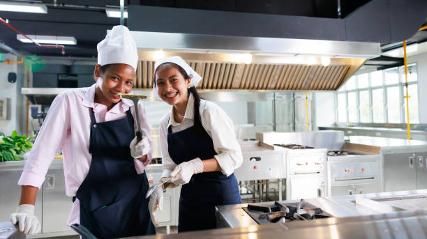 istock Group portrait young wman cooking student. Cooking class. culinary classroom. group of happy young woman multi - ethnic students are focusing on cooking lessons in a cooking school. 1402628197