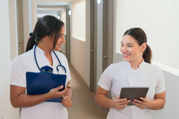 istock Female doctors talking while walking on hospital 1402628794