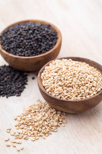 istock White sesame and black sesame seed on wooden bowl. 1402629560