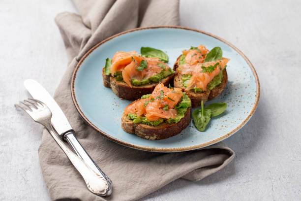 istock Salmon avocado keto sandwiches on healthy seed buns. 1402629687