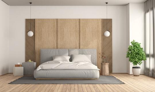Minimalist bedroom with gray double bed against wooden panel - 3d rendering
 Note: room does not exist in reality, Property model is not necessary